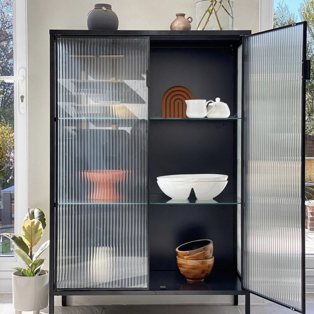 A cabinet with the reeded film design